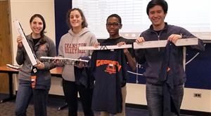 Teachers and students holding model bridges 